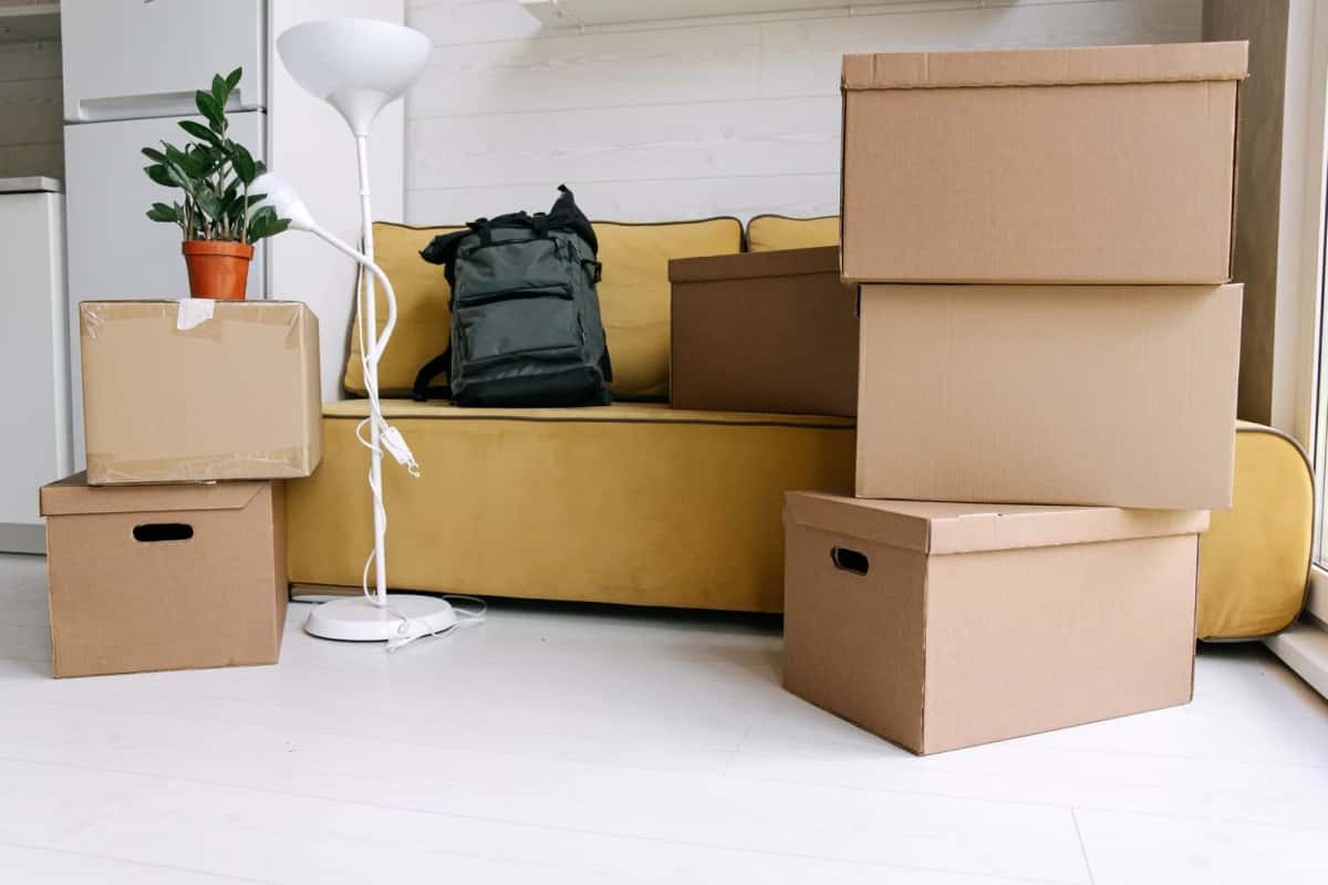 Des cartons de déménagement empilés dans le salon d'un appartement fraîchement occupé